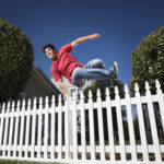 Man jumping over fence